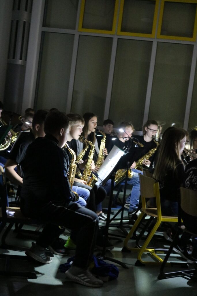 Musikgruppe mit Saxophonspielern auf einer Bühne bei einer Aufführung.