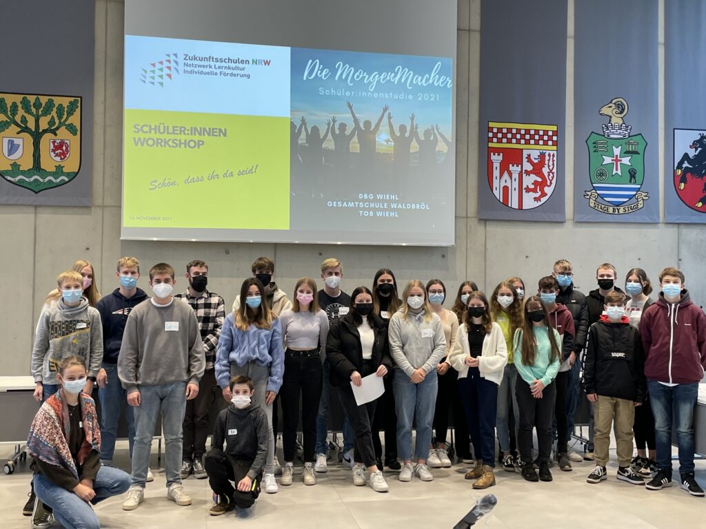 Gruppenfoto von Schülern in einem Workshop, alle tragen Masken.