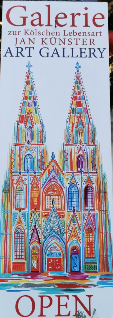 Buntes Plakat einer Galerie mit Abbildung von Kirchtürmen und der Aufschrift „OPEN“.