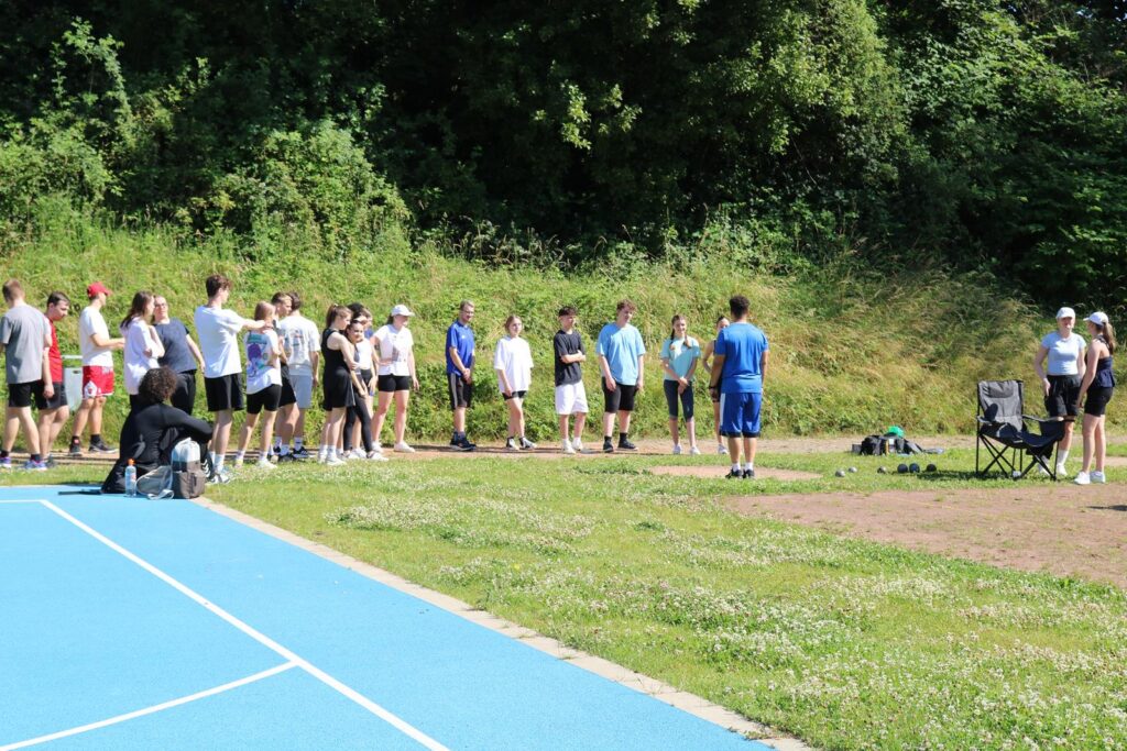 Sportgruppe auf einem Außensportplatz, Training in der Natur.