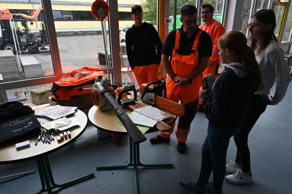 Besucher schauen sich Ausrüstung bei einem Informationsstand an.