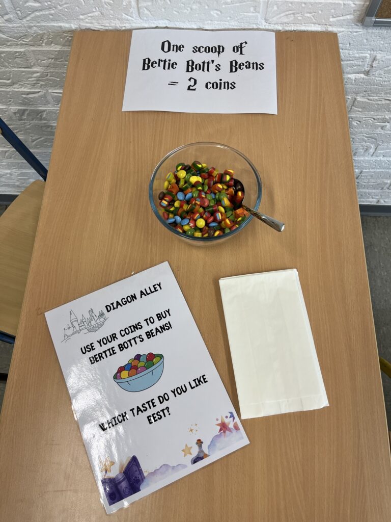 Schüssel mit bunten Süßigkeiten und Informationsblatt auf einem Tisch.